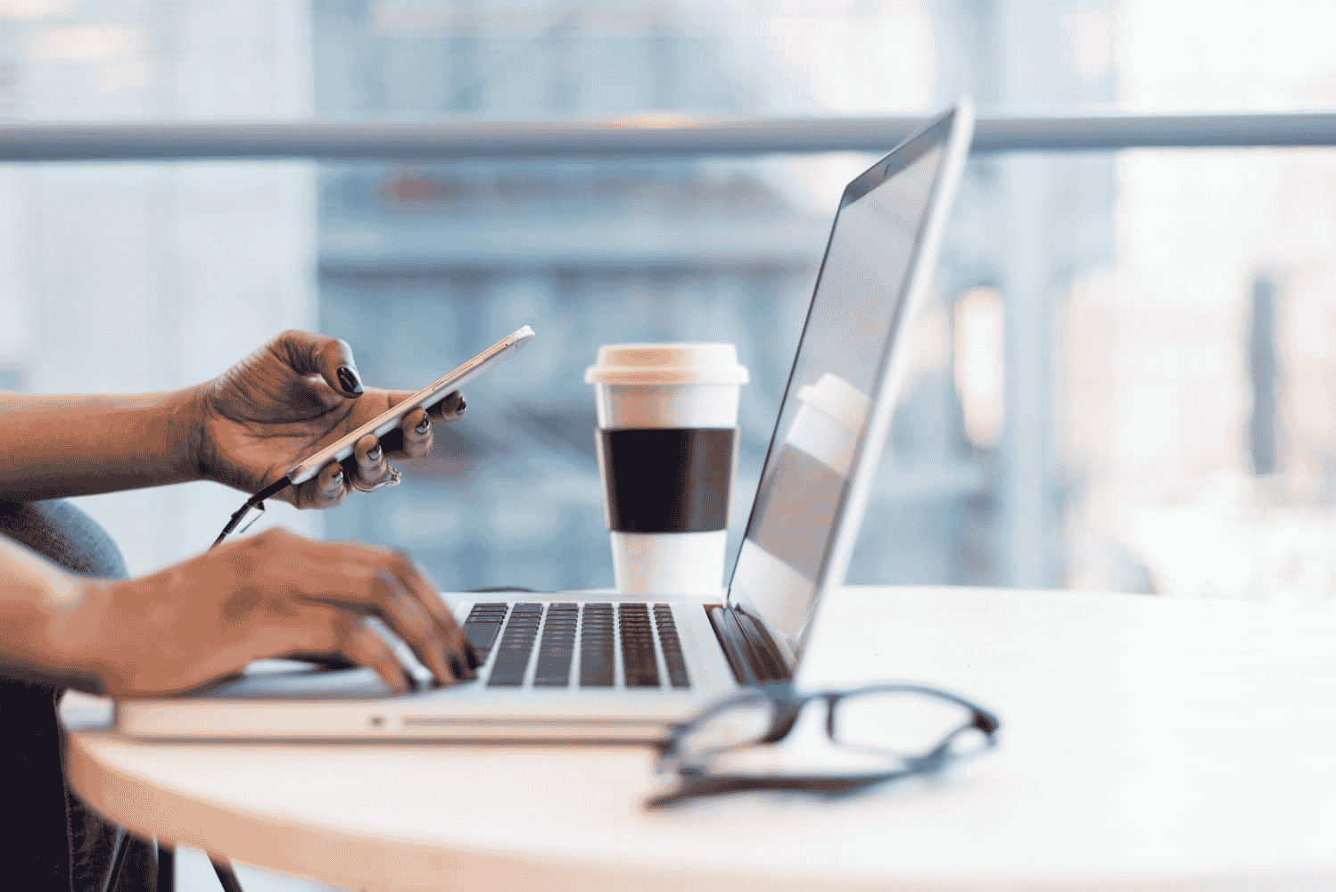 Virtual Assistant working on phone and laptop