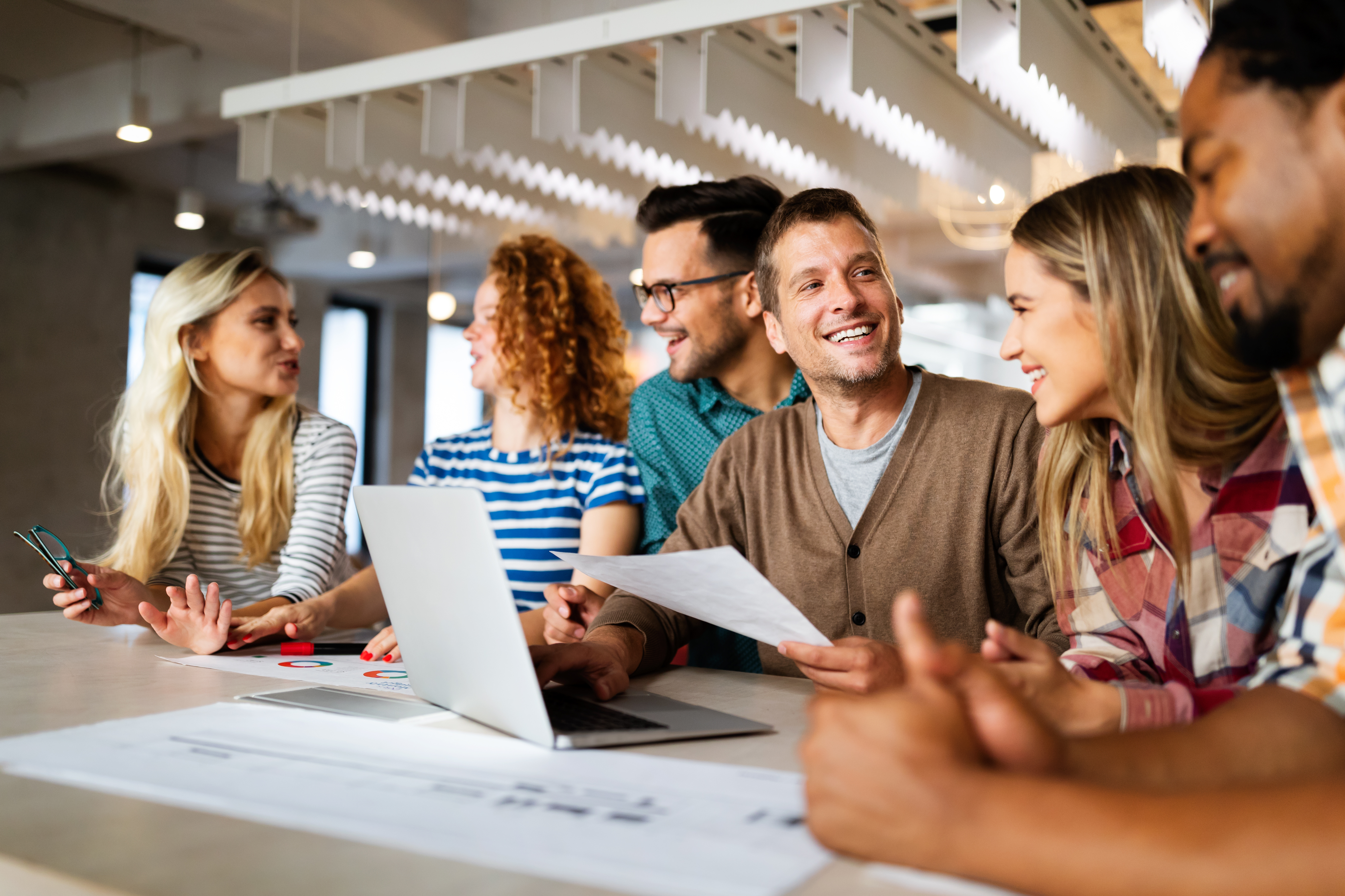Diverse team of colleagues working together at office meeting