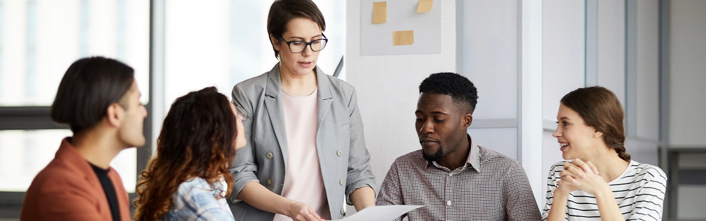 Businesswoman leading meeting with colleagues in office